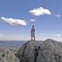 Man on top of rock enjoying the view of Custer State Park